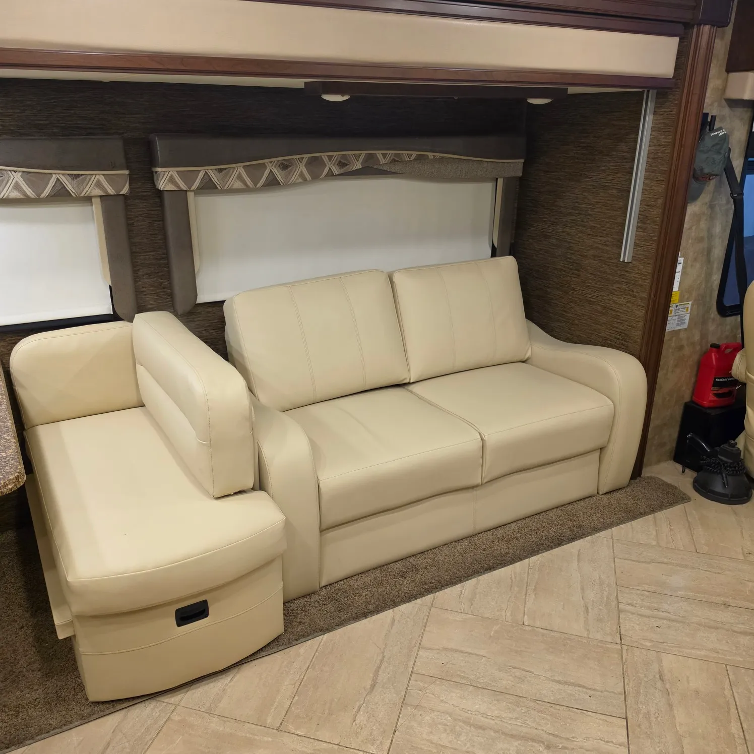 2019 31B with a living room featuring a couch and a table, as well as a carpet on the floor